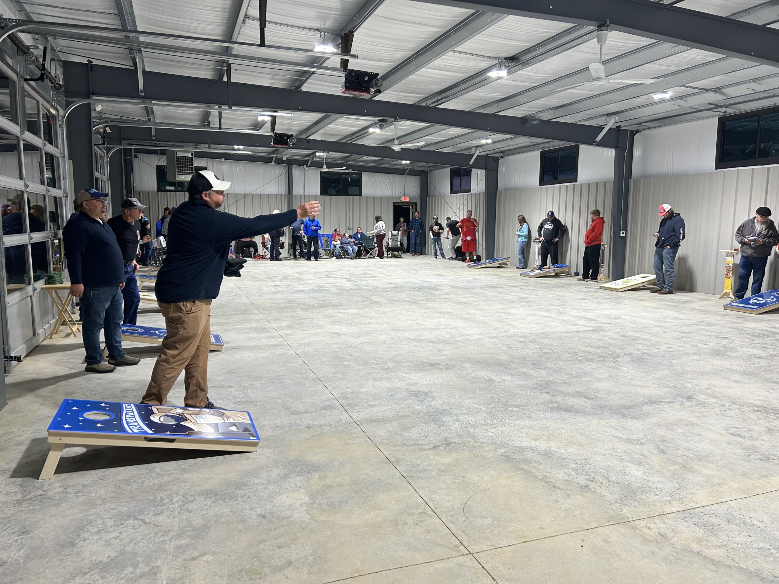Customers Playing Cornhole In Transparent Brewing Companys Expansion Building