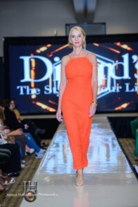 Theresa Pittman modeling an orange dress.